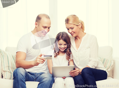 Image of parents and girl with tablet pc and credit card
