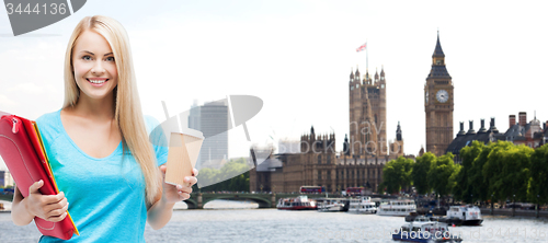 Image of smiling student girl with folders and coffee cup