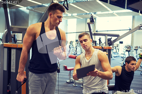 Image of men exercising on gym machine