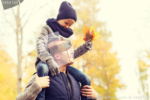 Image of happy family having fun in autumn park