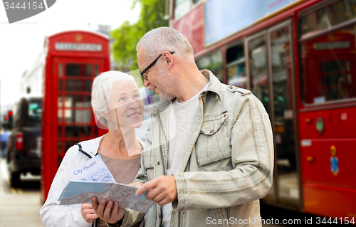 Image of senior couple with map on london in city street