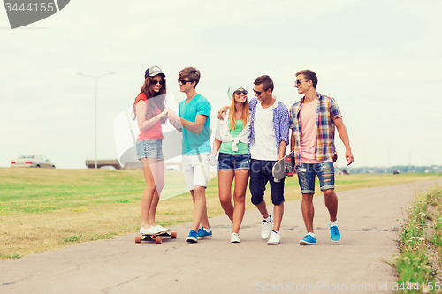 Image of group of smiling teenagers with skateboards