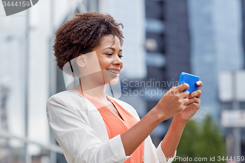 Image of happy african businesswoman with smartphone