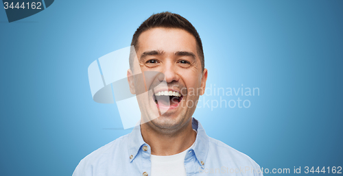 Image of laughing man over blue background