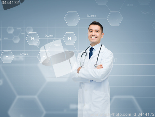 Image of smiling male doctor over chemical formula