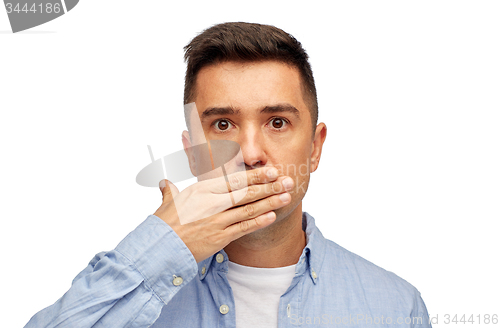 Image of face of man covering his mouth with hand palm