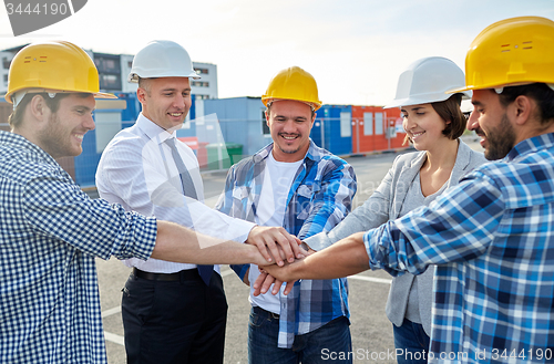 Image of builders and architects with hands on top