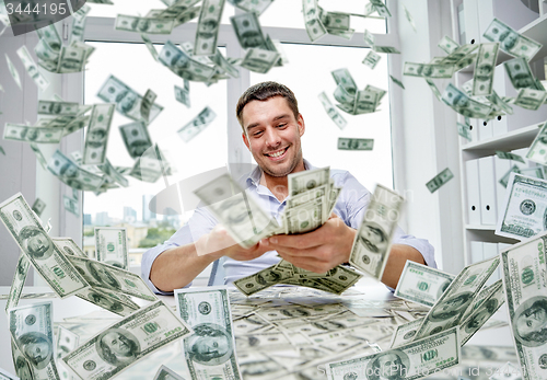 Image of happy businessman with heap of money