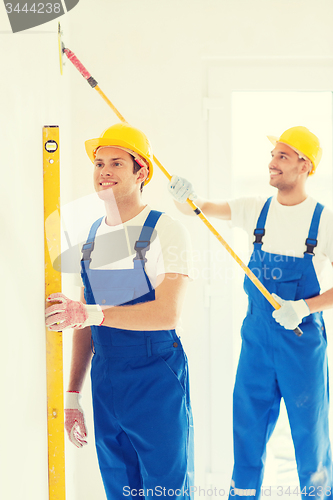 Image of group of builders with tools indoors