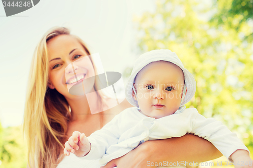 Image of happy mother with little baby in park