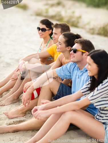 Image of group of happy friends on beach