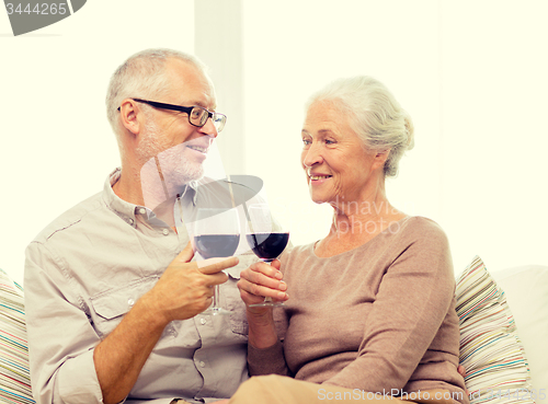 Image of happy senior couple with glasses of red wine