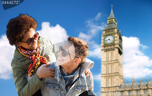 Image of happy teenage couple having fun over big ben tower