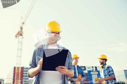 Image of group of builders in hardhats outdoors