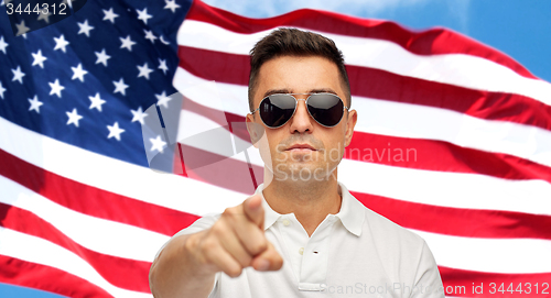 Image of man pointing on you over american flag background