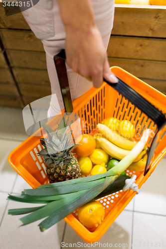 Image of close up of woman with food basket in market