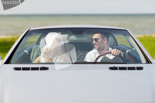 Image of happy man and woman driving in cabriolet car