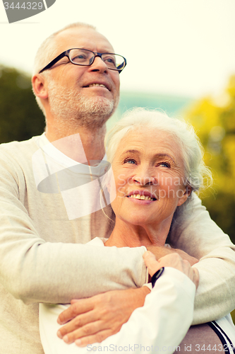 Image of senior couple hugging in park