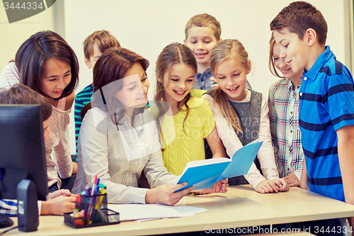 Image of group of school kids with teacher in classroom