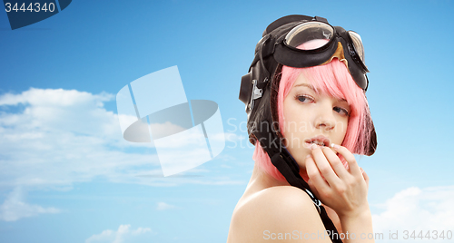 Image of pink hair girl in aviator helmet over blue sky