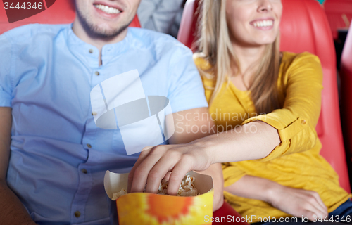 Image of happy couple watching movie in theater or cinema