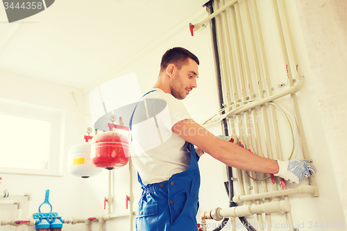 Image of builder or plumber working indoors