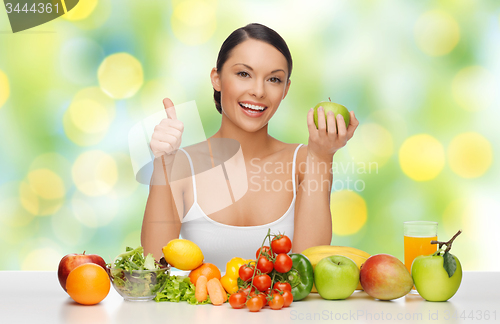 Image of happy woman with healthy food showing thumbs up