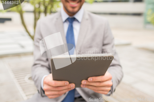 Image of close up of business man with tablet pc in city