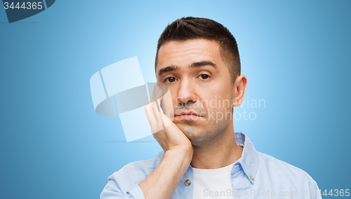 Image of bored middle aged man face over blue background