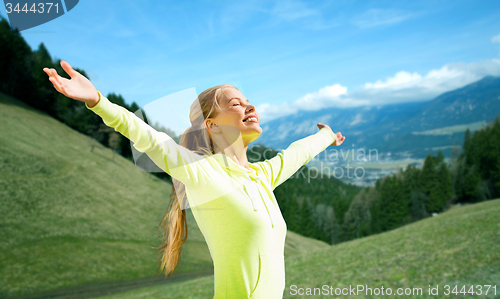 Image of happy woman in sportswear enjoying sun and freedom