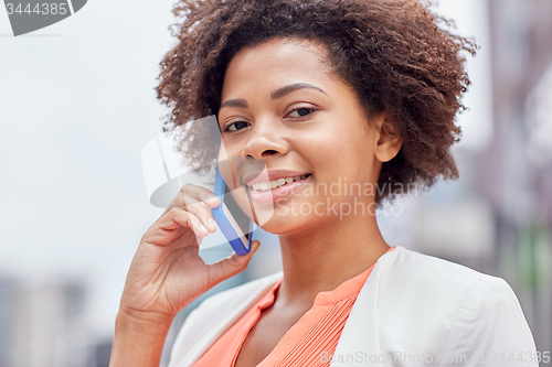 Image of happy young african american businesswoman in city