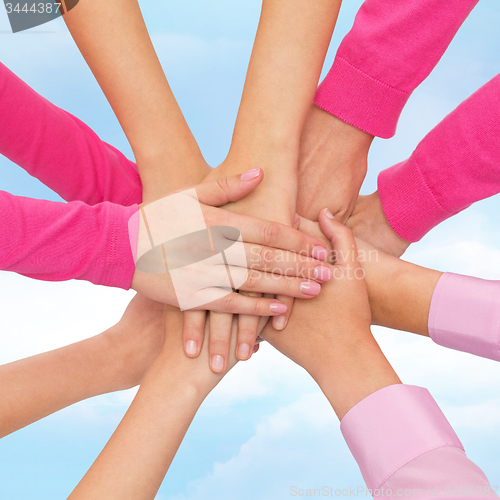 Image of close up of women with hands on top