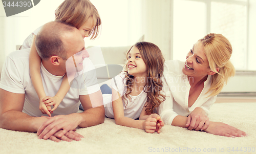 Image of parents and two girls lying on floor at home