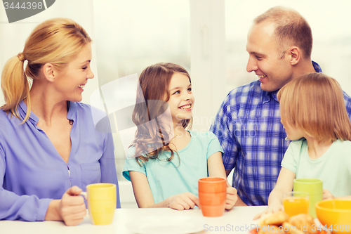 Image of happy family with two kids with having breakfast