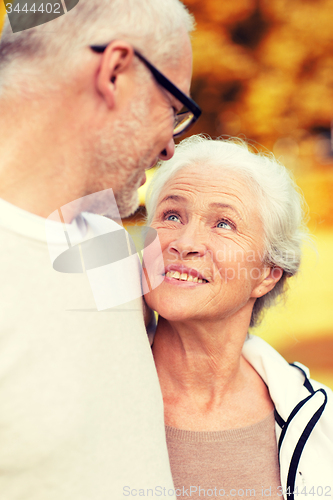 Image of senior couple hugging in city park