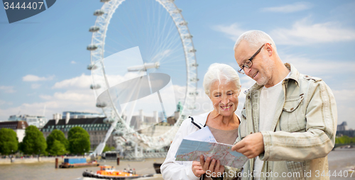 Image of senior couple with map over london eye