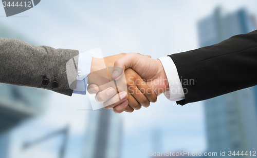 Image of businessman and businesswoman shaking hands