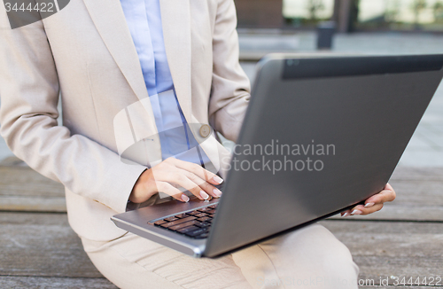 Image of close up of business woman with laptop in city