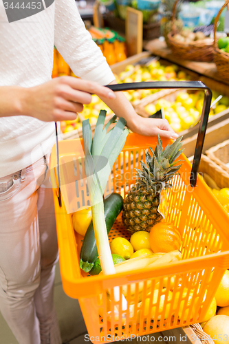 Image of close up of woman with food basket in market