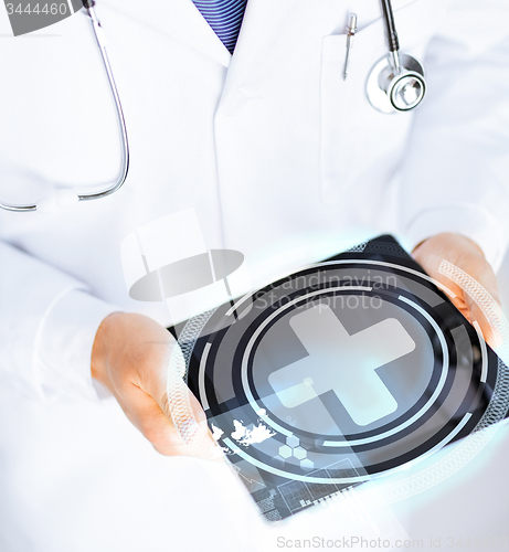 Image of male doctor holding tablet pc with medical app