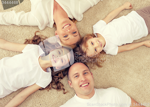 Image of parents and two girls lying on floor at home