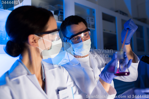 Image of close up of scientists making test in lab