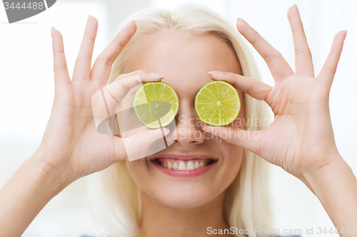 Image of happy woman having fun covering eyes with lime