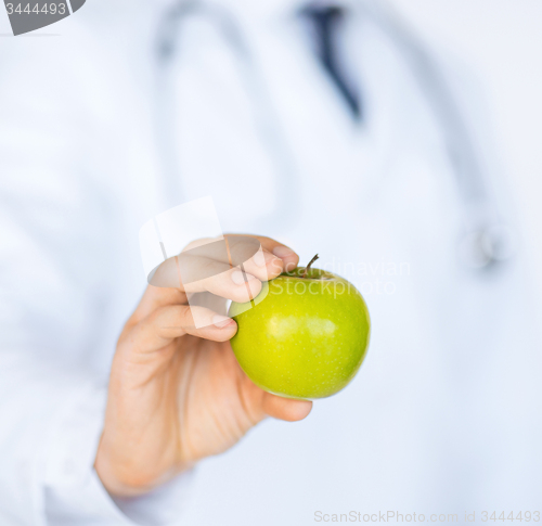 Image of male doctor with green apple