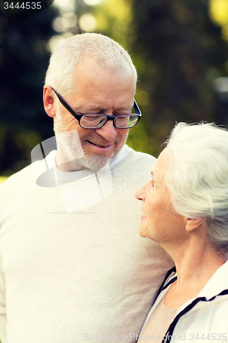 Image of senior couple hugging in city park