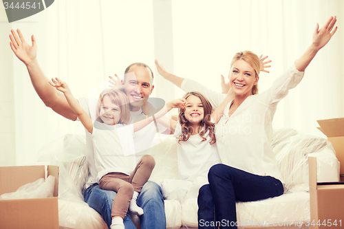 Image of smiling parents and two little girls at new home