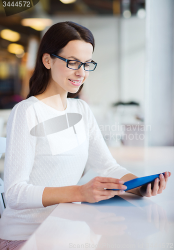 Image of smiling woman with tablet pc at cafe