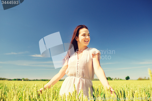 Image of smiling young woman on cereal field