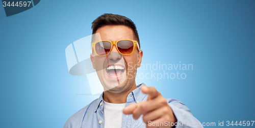 Image of face of laughing man in shirt and sunglasses