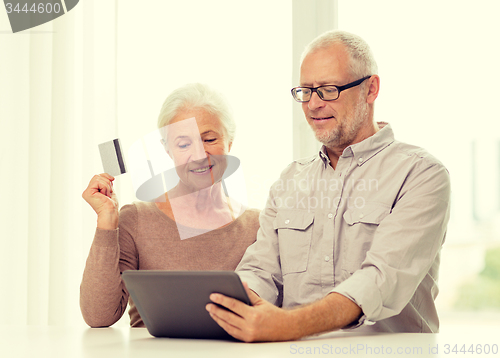 Image of happy senior couple with tablet pc and credit card